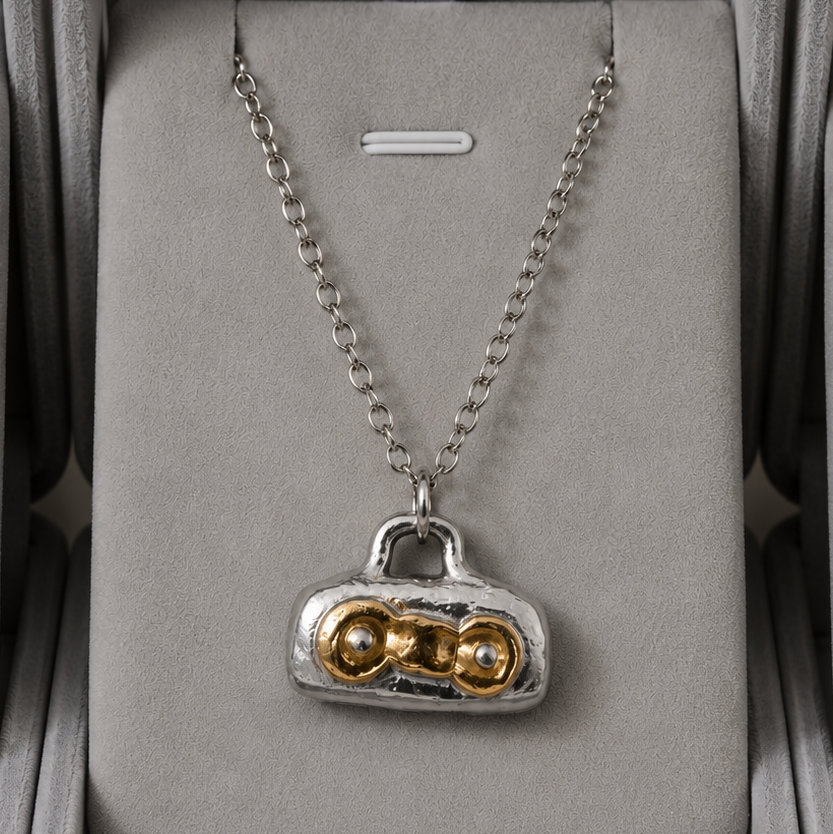 Necklace with a unique pendant in a gray jewelry box