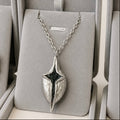 Silver necklace with a unique pendant in a gray jewelry box