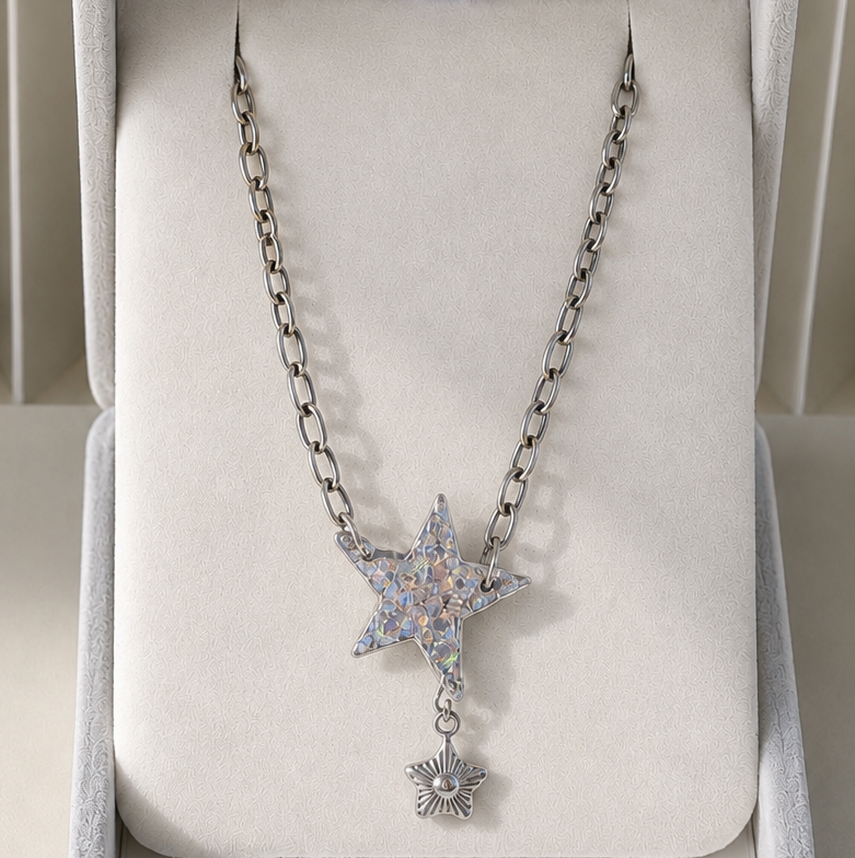 Silver necklace with star-shaped pendant in a jewelry box