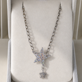 Silver necklace with star-shaped pendant in a jewelry box